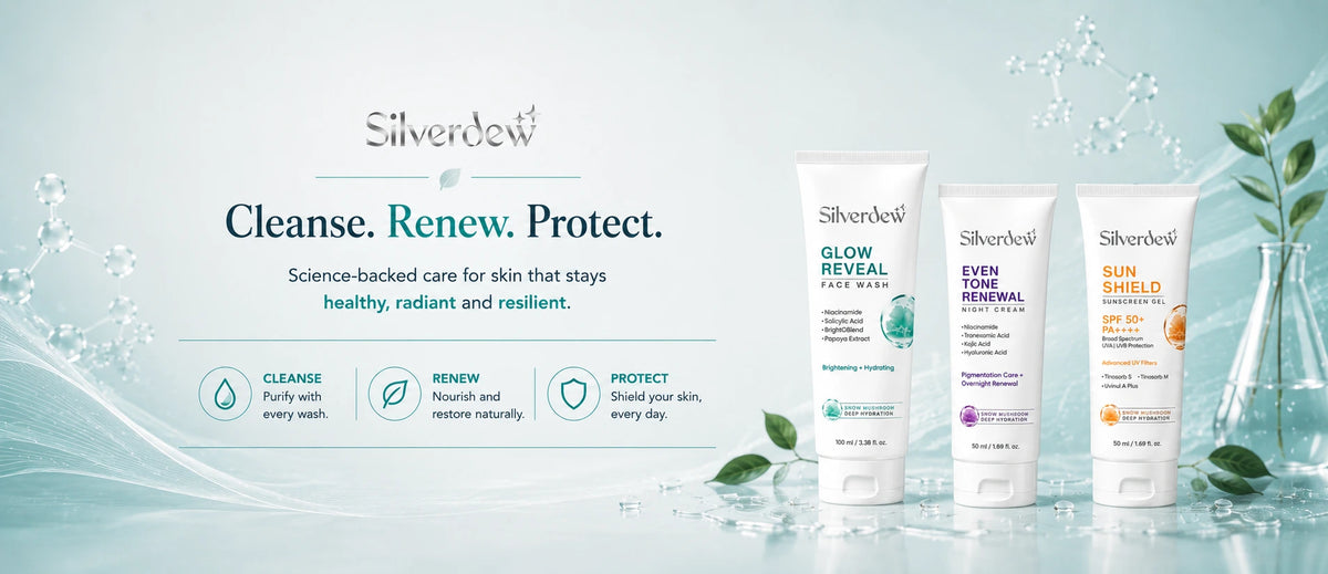 Silver Belt skincare set featuring three white tubes of 'Glow Reveal', 'Even Tint', and 'Sun Block' sunscreen on a light blue background with water droplets and leaves.